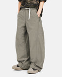 Model seated wearing Cordura nylon pants showing comfortable relaxed fit