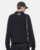 model back view wearing black long sleeve polo shirt