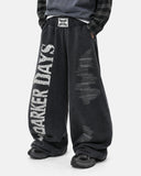 side view of black graphic barrel sweatpants on model