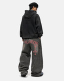 model wearing grey washed barrel jeans back view