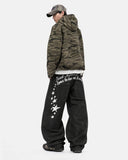 model wearing raw black graphic jeans back view