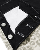 adjustable strap and button detail on black bib overalls