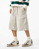 Male model beige oversized cargo knee shorts