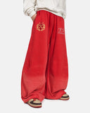 model wearing red washed graphic barrel sweatpants