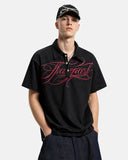 model wearing black polo t shirt with red embroidery