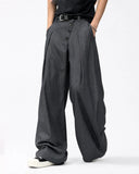 model wearing grey barrel tailored pants front view