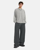 Model wearing gray long sleeve shirt and dark gray wide leg pants streetwear outfit