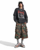 Below-knee camo cargo shorts with red floral print detail