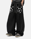 model wearing black star graphic barrel sweatpants front view