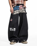 on-body front view of distressed graphic barrel jeans