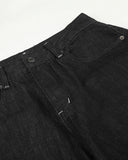 raw black denim waistband and pocket detail close up