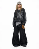 model styled in charcoal long sleeve graphic t shirt with wide leg pants