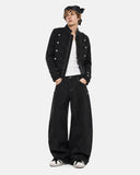 model styling black napoleon-inspired denim jacket with wide-leg pants
