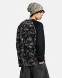 model wearing charcoal camo long sleeve tee with wide leg pants