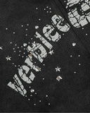 close-up of distressed graphic print with rhinestone embellishments