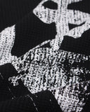 distressed white gothic lettering on black waffle fabric