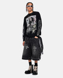 model styling black long sleeve graphic tee with dark streetwear