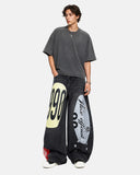 black graphic barrel jeans full-body streetwear styling