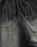 metal eyelet embellishment close-up on black sweatpants