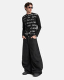 model standing in black distressed graphic t shirt with wide leg pants