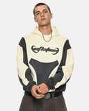 detail view of curved colorblock panel design on boxy hoodie