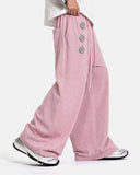 side view of pink button detail wide leg sweatpants on model