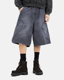 Male model grey washed wide cargo knee shorts