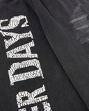 cracked typography graphic detail on black sweatpants