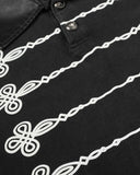symmetrical ornamental front graphic detail on black polo