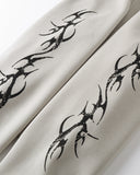 Detail view of pant, black tribal thorn print closeup