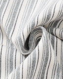 close-up of cuff button detail on striped shirt