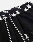 tar waistband and rope drawstring detail on black sweatpants