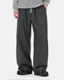 Close-up detail of dark gray cordura nylon wide leg pants with drawstring waist
