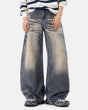 model wearing curved barrel leg denim pants detail