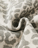leopard print denim fabric close-up with soft washed texture