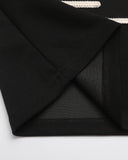 black polo collar and fabric construction detail