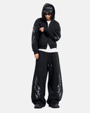Full body shot model wearing black graphic sweatpants