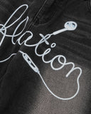 close-up of earphone graphic on baggy jeans