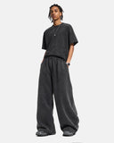model sitting in loose fit casual pants
