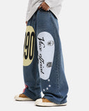 model wearing blue racing graphic barrel jeans side view