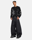 model front view wearing black waffle graphic t shirt with barrel jeans