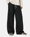 Close-up of black wide leg pants showing fabric texture and pocket details