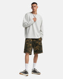camo utility knee-length shorts worn with gray sweatshirt