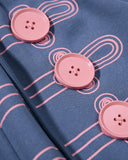 oversized button detail close-up on blue sweatpants