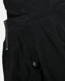 detail view of side pocket and snap button on black cargo pants