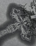 ornate cross and script graphic print close up