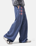 side view of blue button detail wide leg sweatpants on model