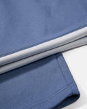 double-faced air-layer fabric and adjustable hem detail on blue sweatpants