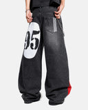 Full body view of wide-leg denim jeans with sneakers