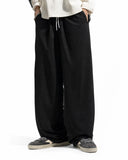 Rear view of black cordura nylon wide leg pants showing fit and hem detail